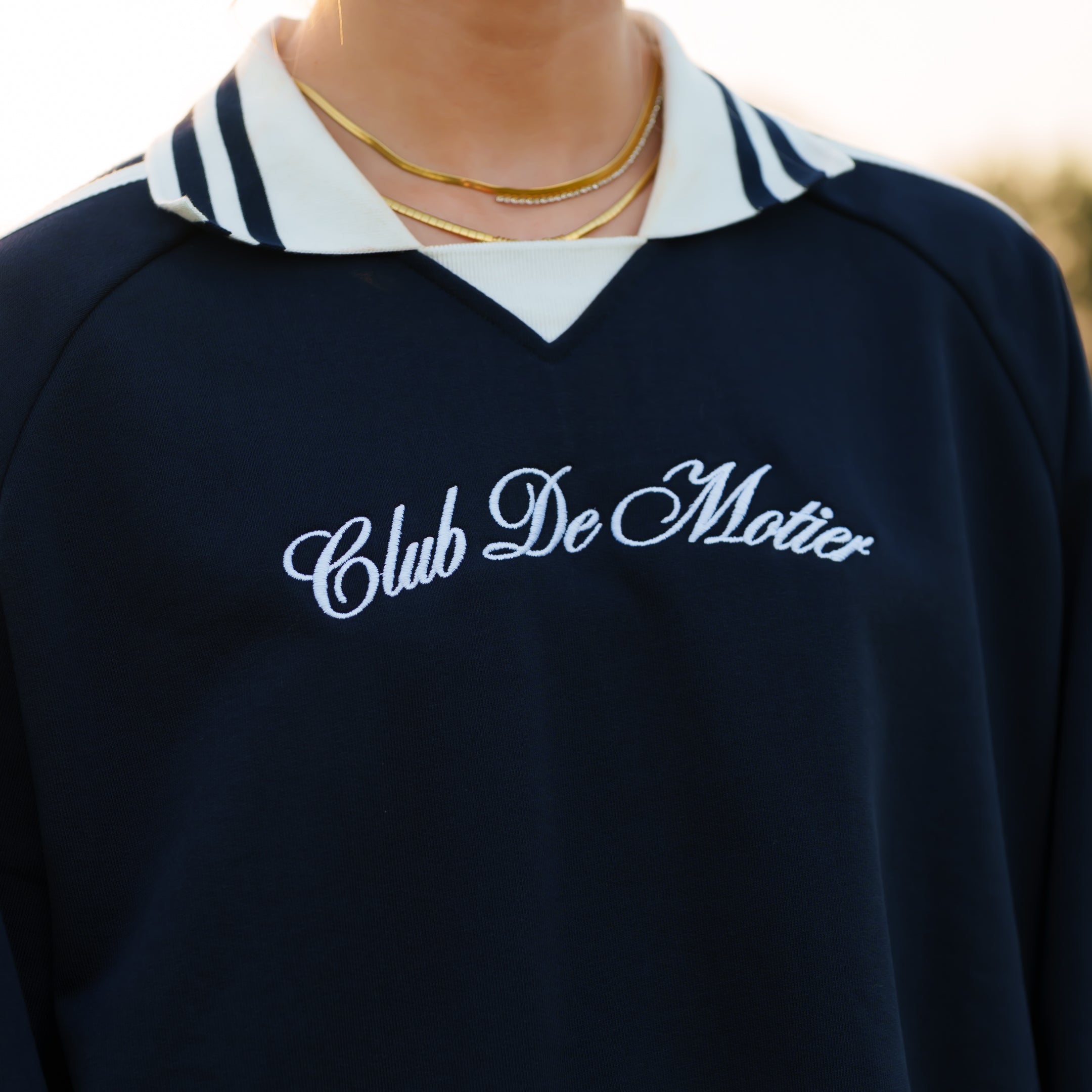Navy Club De Motier varsity pullover by Motier Lafayette featuring contrasting sleeves and classic athletic style.
