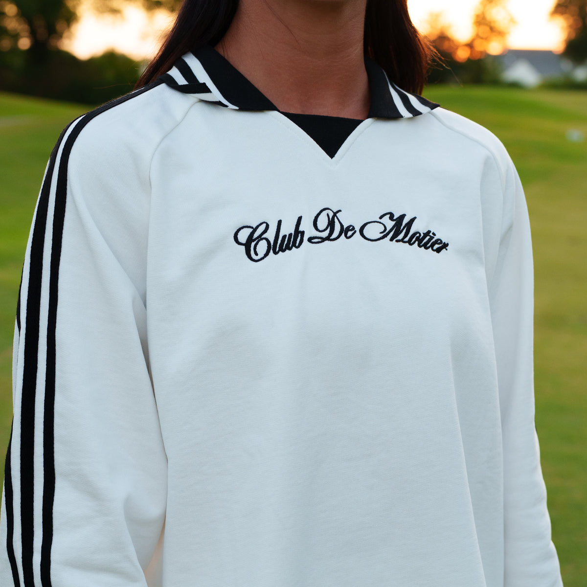 White Club De Motier varsity pullover by Motier Lafayette featuring a classic embroidered crest and ribbed cuffs.