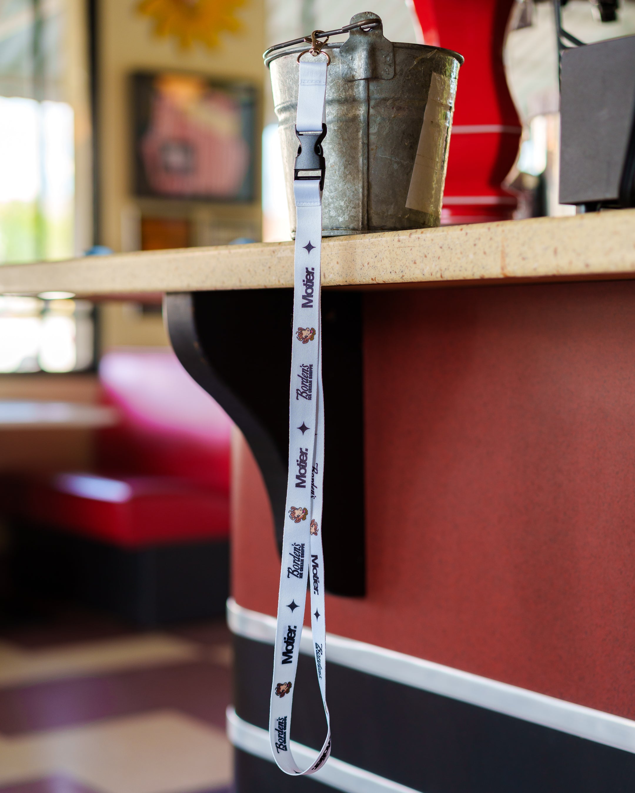 Motier Lafayette Borden's Ice Cream Shoppe lanyard with logo and colorful design, ideal for holding ID badges or keys.