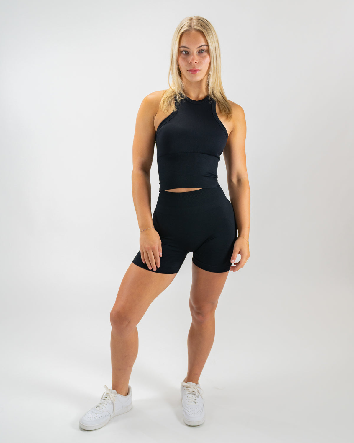 Black Seamless Sculptflex Biker Shorts by Motier Lafayette, close-up of the stretchy, form-fitting seamless athletic bottoms.