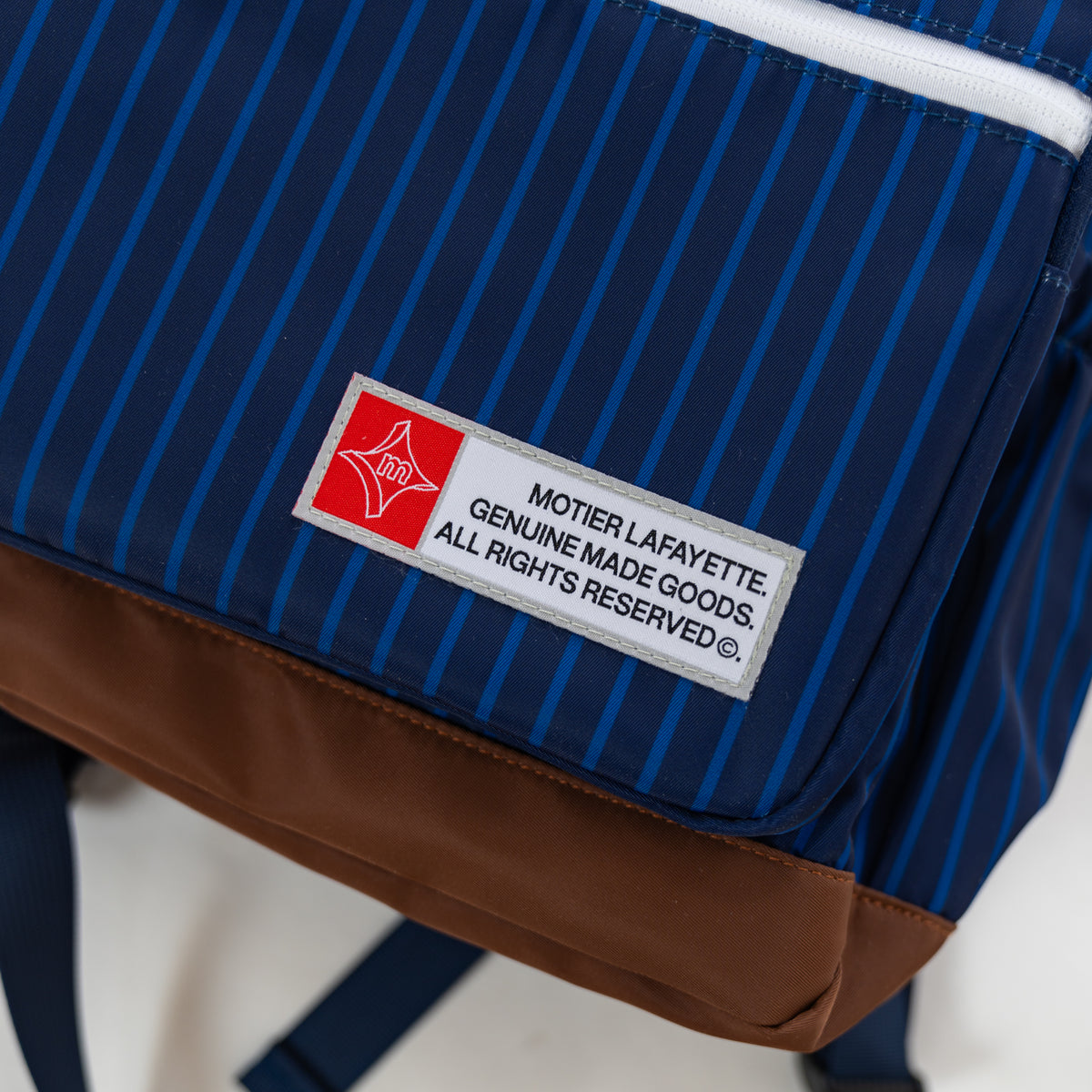 Motier Lafayette The Legacy II Navy Pinstripe Backpack with adjustable straps and multiple compartments.