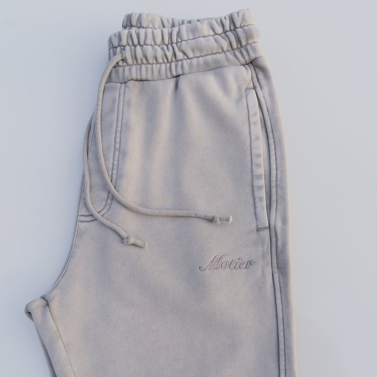 Motier Lafayette Vital Signature Sweatpants in Paloma color, with a relaxed fit and comfortable fabric, shown on a model.