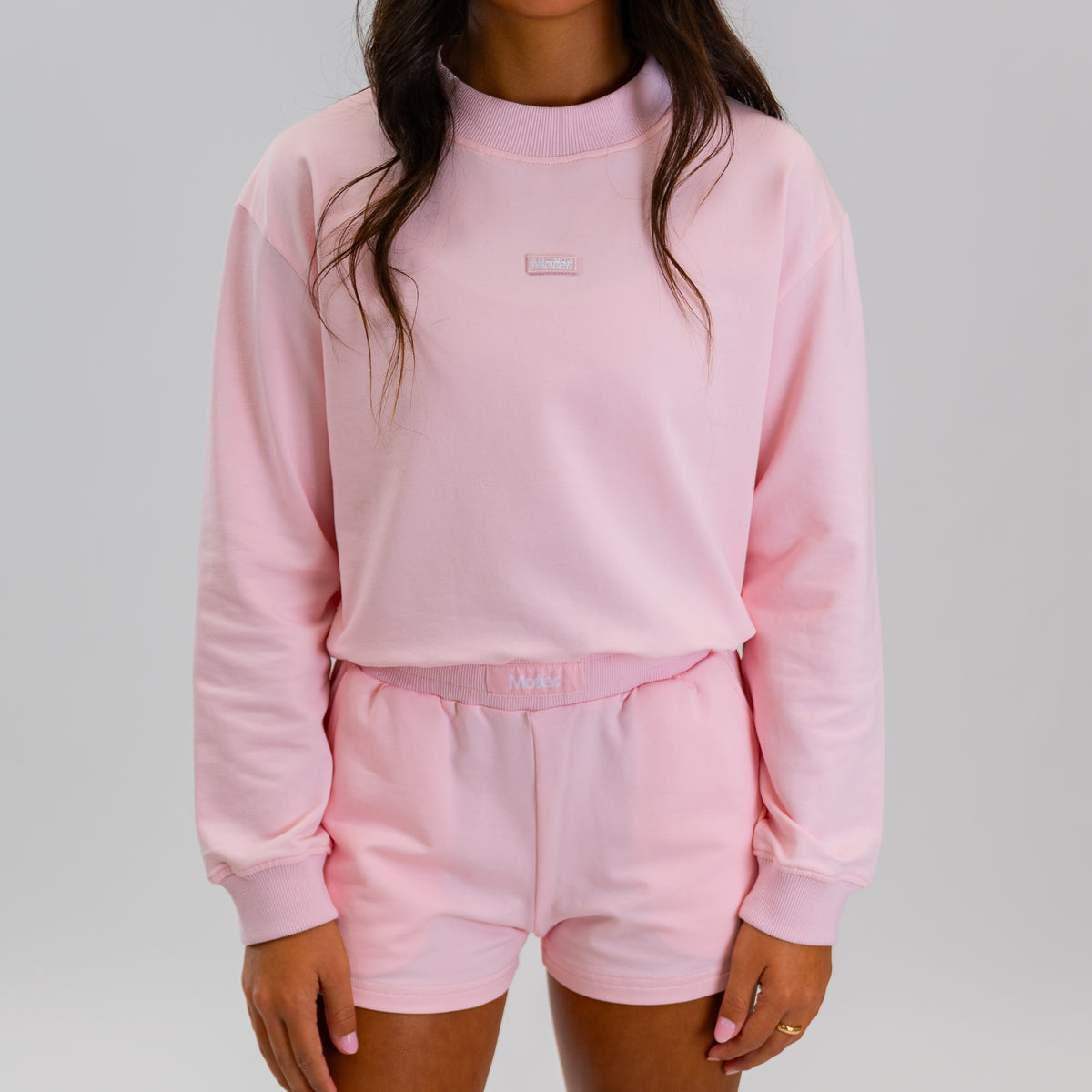 Motier Lafayette The Refresh Pullover in blush pink, soft knit fabric, displayed on a hanger with a casual, cozy fit.