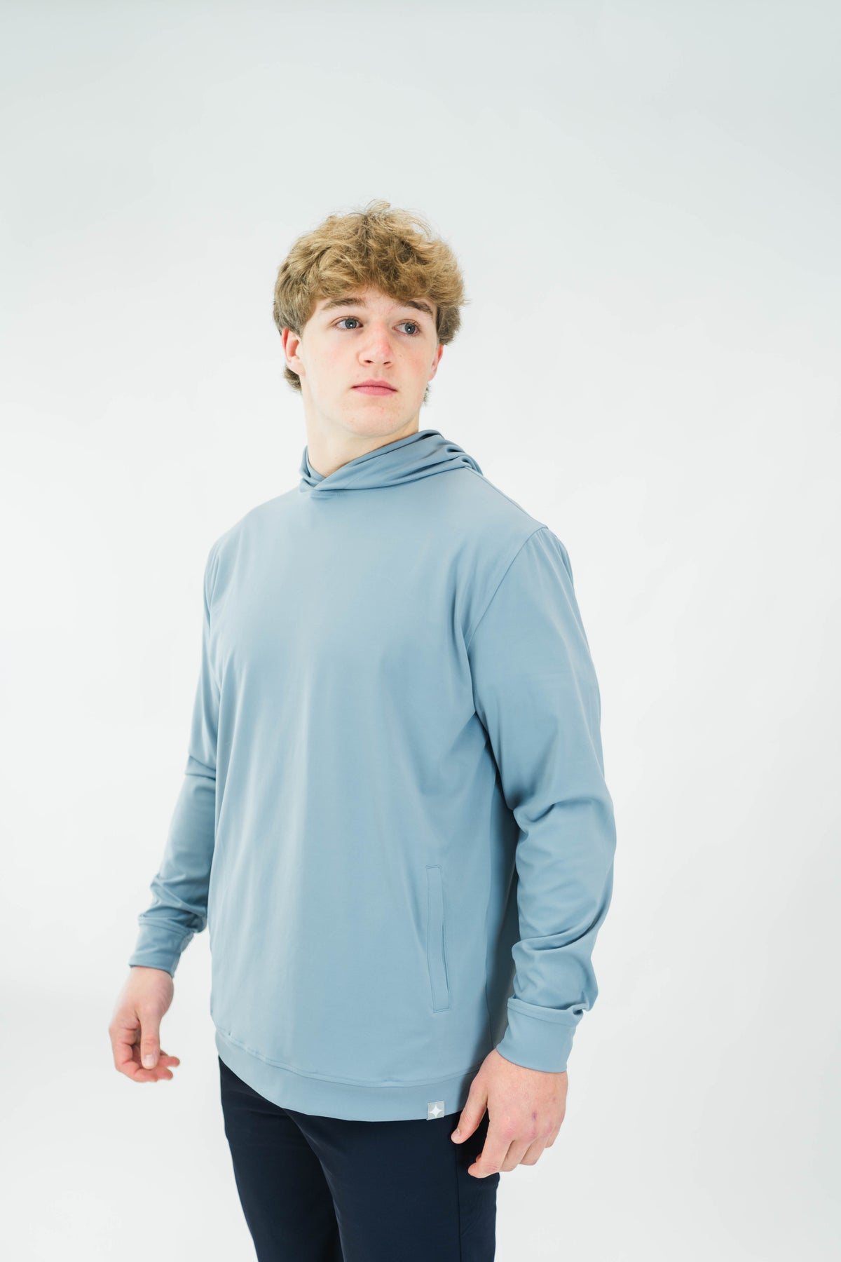 Motier Lafayette Riviera Lightweight Performance Hoodie II in slate blue, showing the hoodie’s front with drawstrings and logo detail.