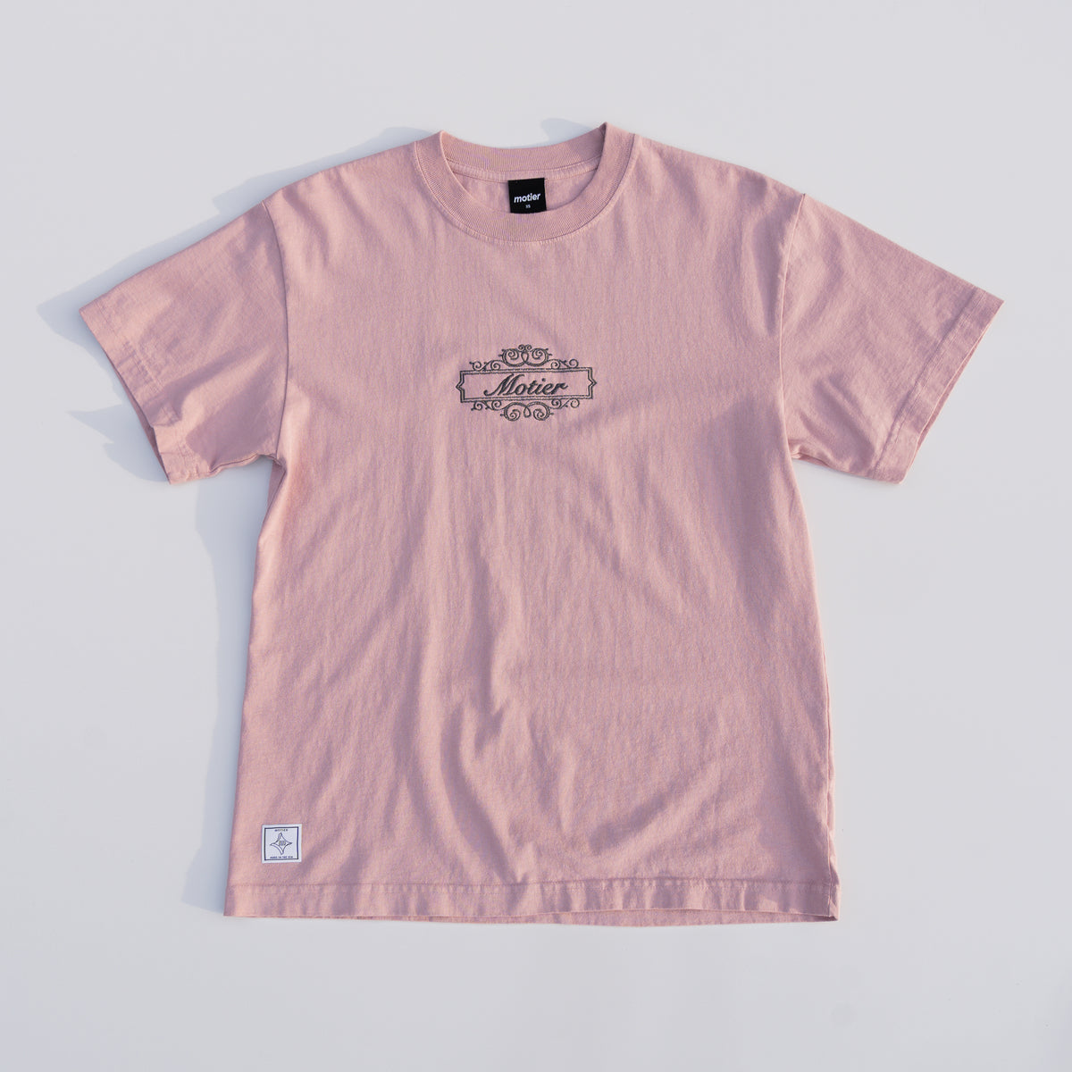 Motier Lafayette Royale Crest Embroidery Luxe Tee in Pale Mauve, close-up of embroidered crest on soft premium fabric.