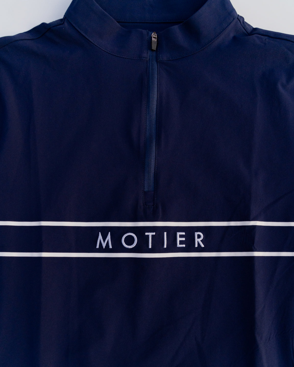 Navy Thomas Élite Pullover by Motier Lafayette displayed on a mannequin, showcasing a stylish knit sweater with a crew neckline.