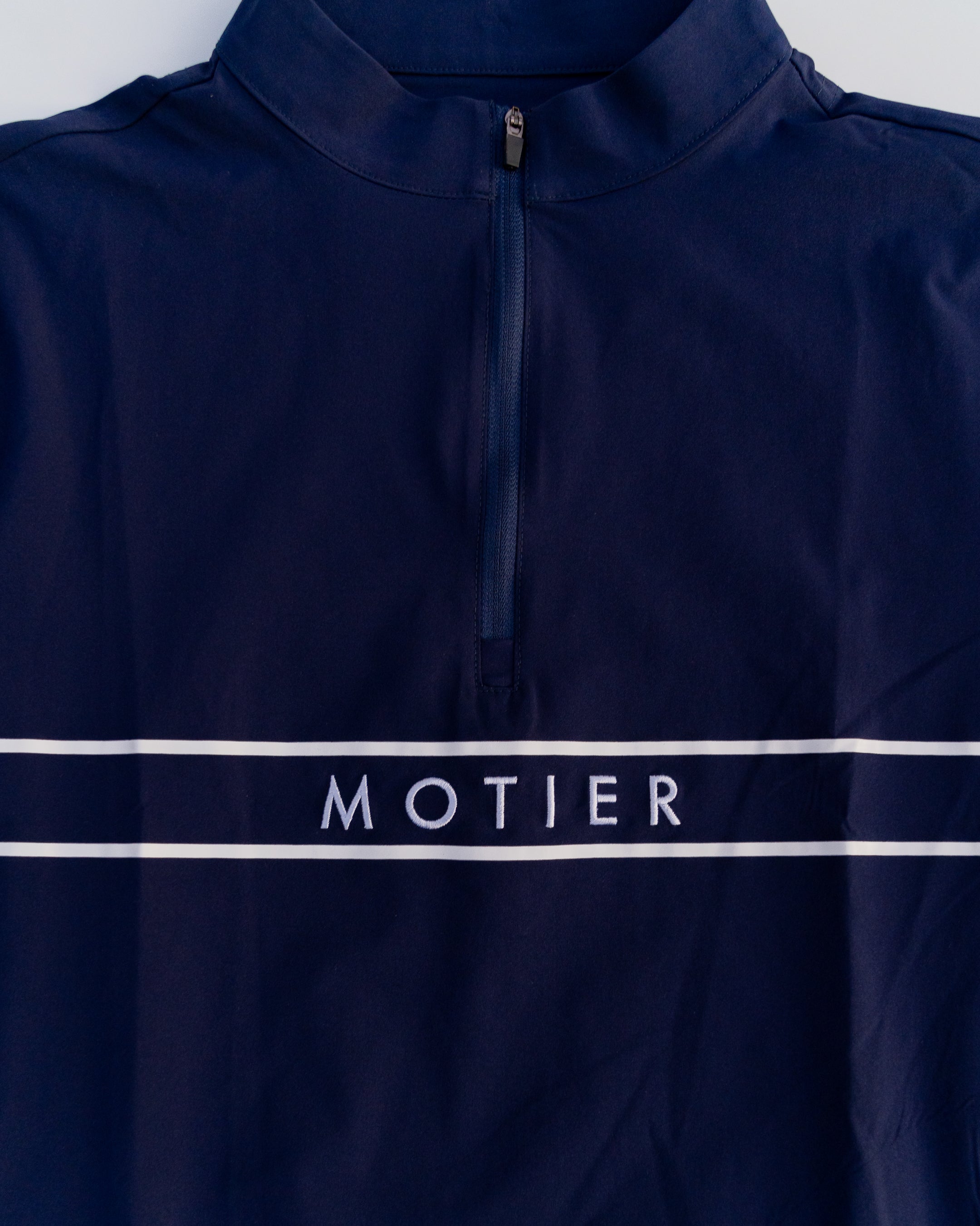 Navy Thomas Élite Pullover by Motier Lafayette displayed on a mannequin, showcasing a stylish knit sweater with a crew neckline.