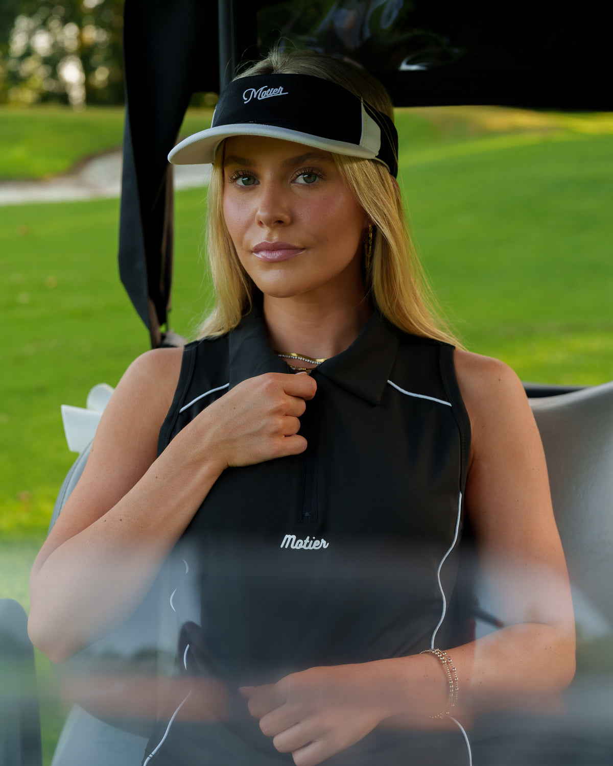 Motier Lafayette black Performance Zip Polo shirt displayed on a mannequin, featuring a front zipper and athletic fit.