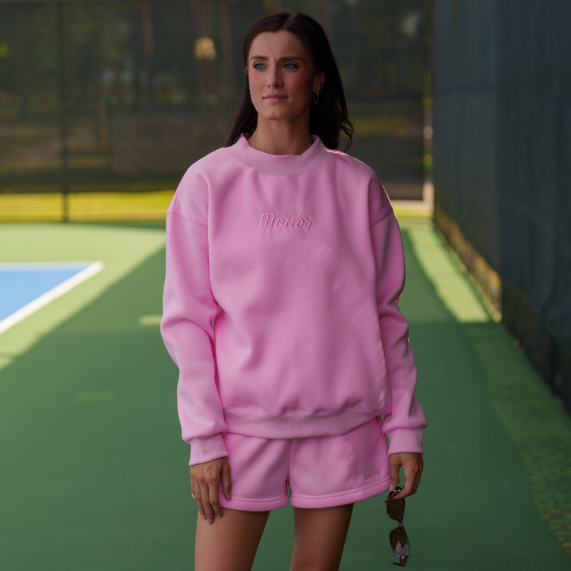 Pink Script Relaxed Sweatshorts by Motier Lafayette, featuring a casual fit and comfortable fabric, displayed on a neutral background.